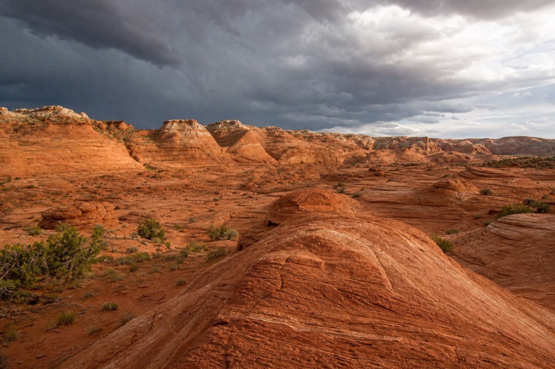 Wide desert landscape near Page Arizona with storm clouds building over sandstone ridges