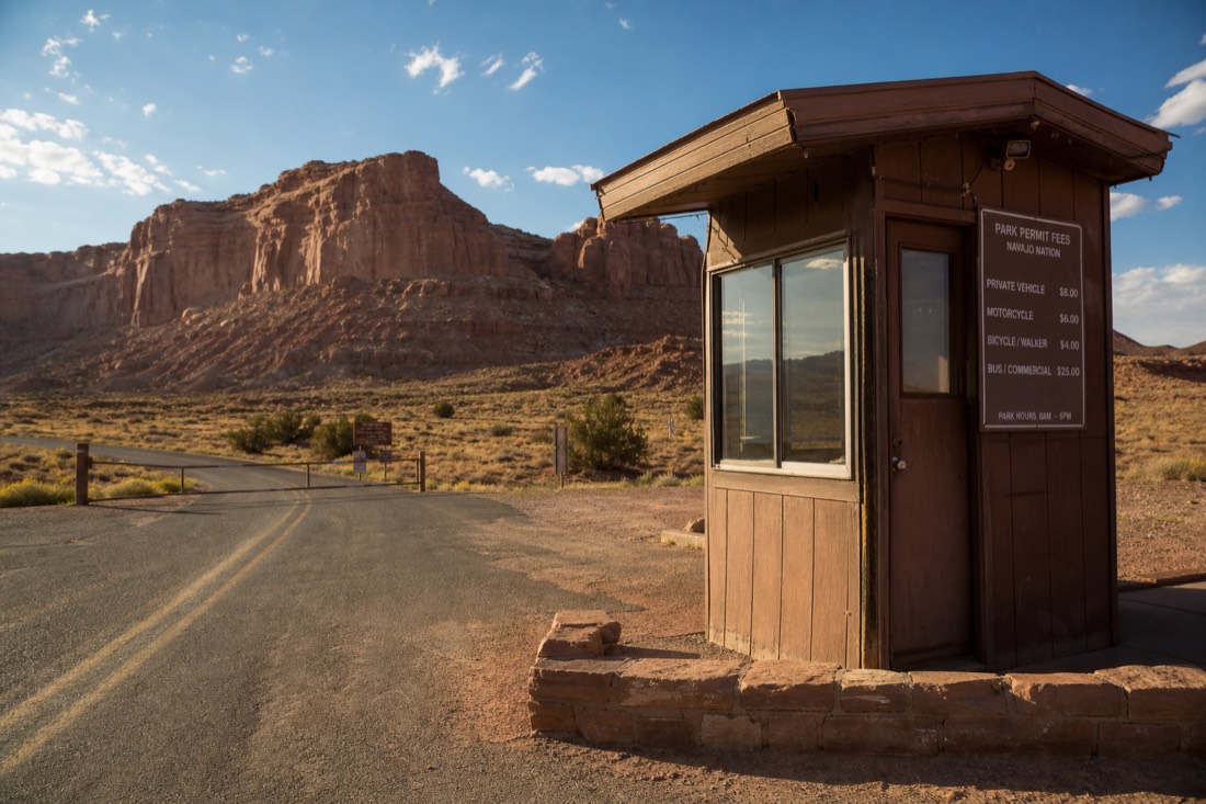 Entry booth with fee signage at the edge of Navajo Nation tribal park land