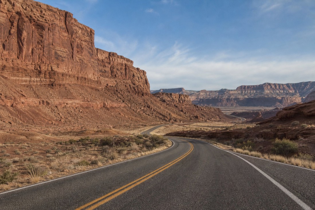 Road map style view of desert highway winding between canyon country landmarks