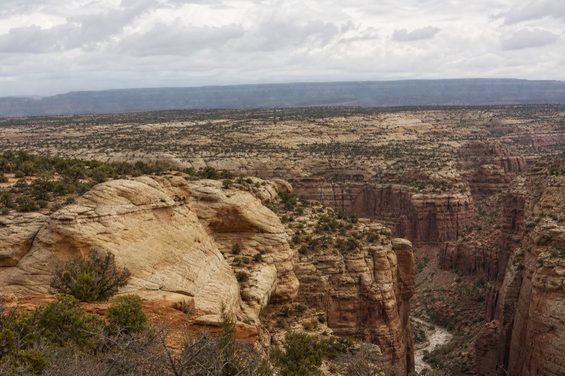 Hazy overcast sky over slot canyon rim country with flat, shadowless light on the sandstone