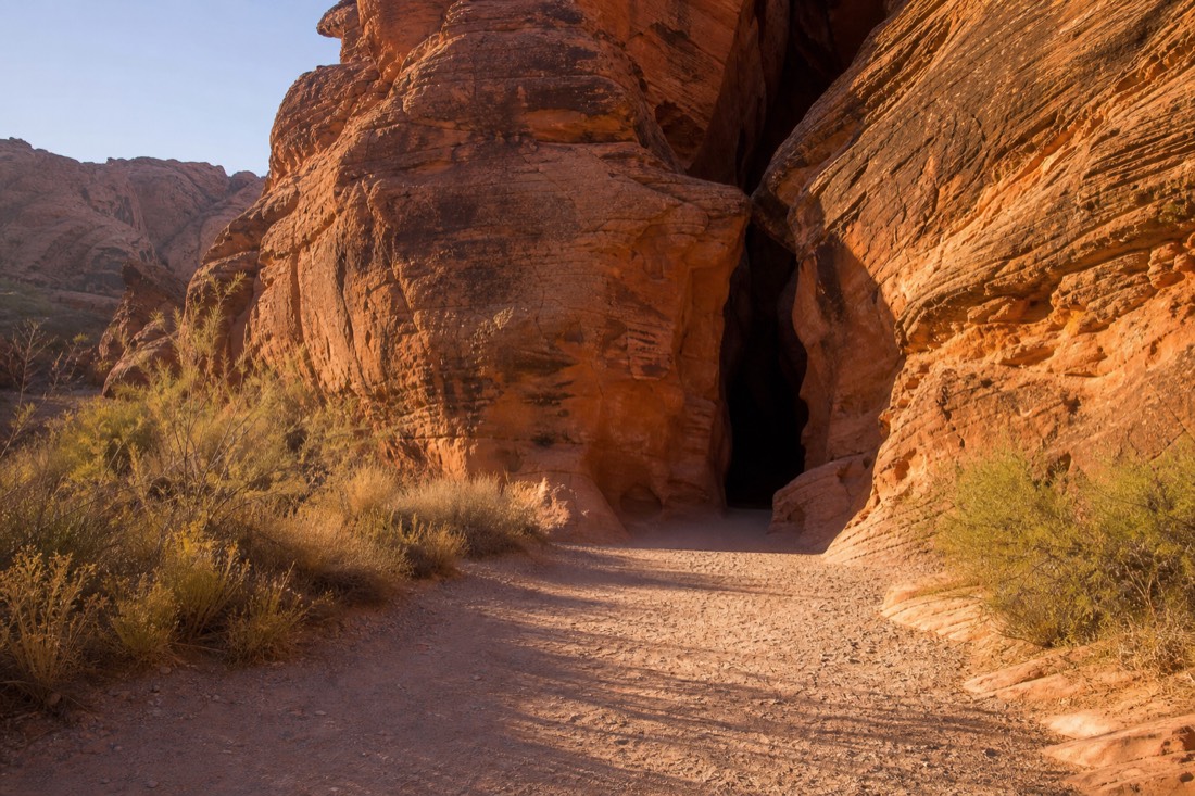 Quiet October morning at a slot canyon entrance path with long shadows and no queue