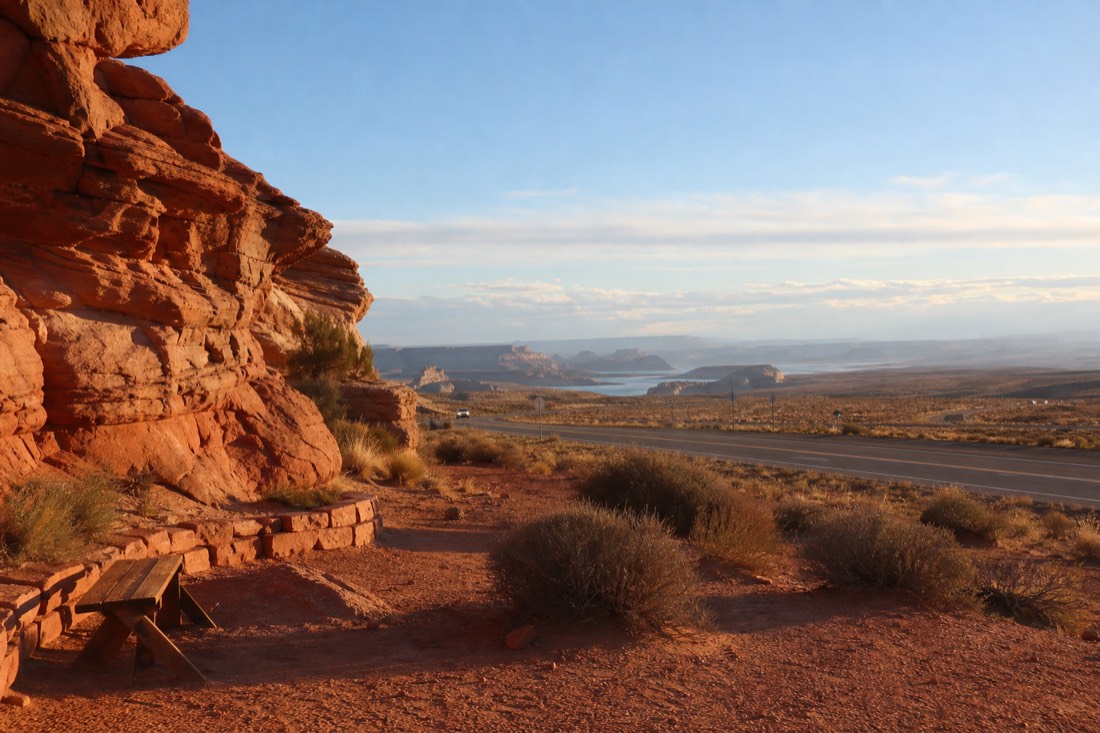 Morning light on Highway 98 east of Page with a slot canyon tour check-in area and desert stretching toward Lake Powell
