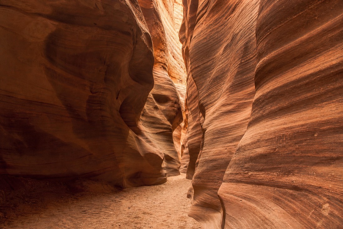 Soft light falling on undulating canyon walls in an empty quiet slot passage