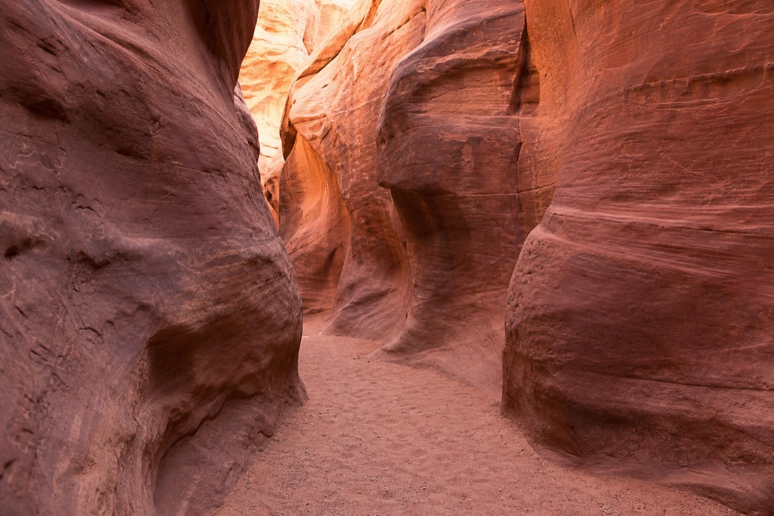 Ladder of slot canyon moods from a packed corridor to an empty sandstone passage in soft light